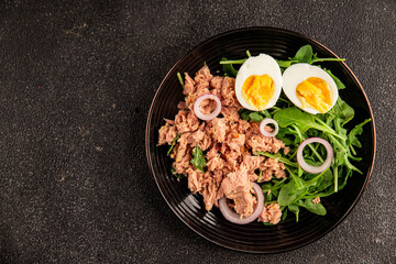 Tuna salad egg, arugula, vegetables tasty snack fresh delicious gourmet food background on the table rustic food top view copy space keto and paleo diet food pescetarian diet