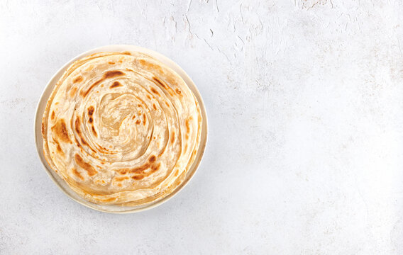Traditional Indian paratha on white background. Indian food. Top view. Copy space.