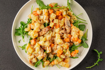 Potato salad with smoked fish tasty snack fresh delicious gourmet food background on the table rustic food top view copy space