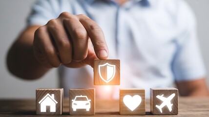 Hand selecting shield icon cube from insurance blocks
