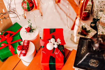 Holiday presents decorated with ribbons and ornaments in a cozy living room