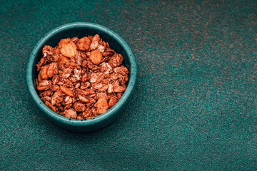 Crunchy granola bowl on textured surface with rich colors and appealing texture