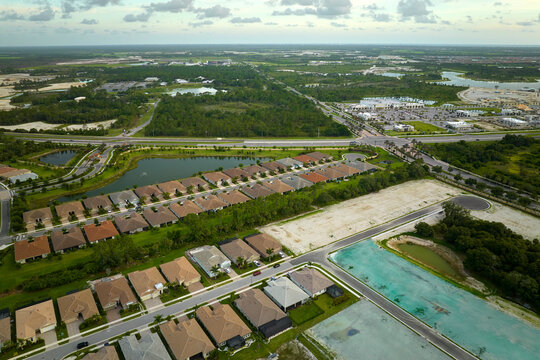 View from above of densely built residential houses under construction in closed living clubs in south Florida. American dream homes as example of real estate development in US suburbs