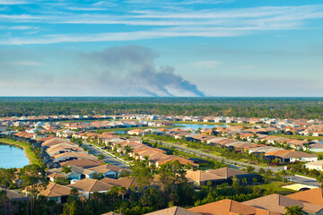 Air pollution with toxic smoke from prescribed forest fire close to rural neighborhood in Florida, USA