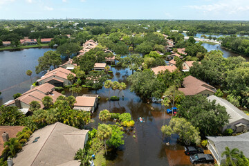 Naklejka premium Flooded residential area with underwater cars and houses from hurricane Debby rainfall water in Sarasota, Florida. Aftermath of natural disaster in southern USA