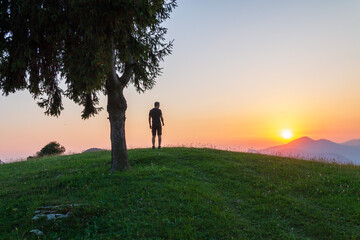 silhouette of a woman walking on a hill