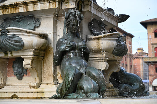 Fontana Del Nettuno With Splashing Water Coming Out Of Young Woman Sculptures In Bologna Italy On A Wonderful Sunny Autumn Day With A Few Clouds In The Sky
