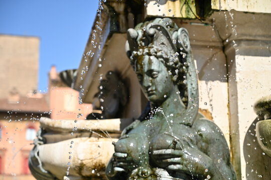 Splashing Water Coming Out Of A Naked Woman Sculpture At Fontana Del Nettuno In Bologna Italy On A Wonderful Sunny Autumn Day With A Clear Blue Sky
