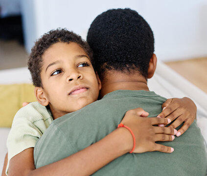 Portrait of son hugging his father, together at home. Son caring for his father, putting hand on his shoulder, comforting and consoling him. Family love, bonding, care and confidence - Powered by Adobe