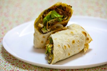 Traditional Mexican food, fajita, tortilla with meat, guacamole, black bean chili and salad