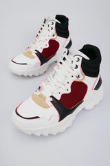 White sport high soled women's basketball shoes, sneakers, 
sports shoes, boots for female isolated on white background. Footwear, pair of running training shoes, side view