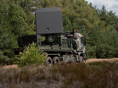 Mobile military radar system mounted on truck in natural field environment