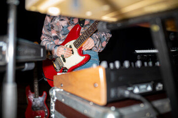 Red guitar performance in professional recording studio environment