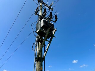 power transformer mounted on an electrical pole, efficiently distributing electricity by reducing 
