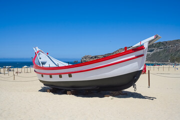 Fototapeta premium Nazare in Portugal, traditional fisher boats on the beach 