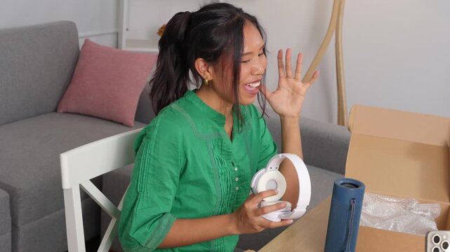 Influencer presenting wireless headphones in slow motion