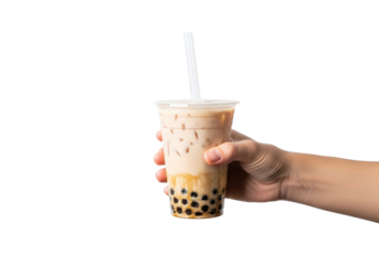 A hand holding a plastic cup of bubble tea with a straw against a black and white background