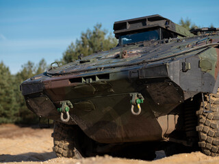 Close-up view of military armored fighting vehicle showing front section and recovery equipment