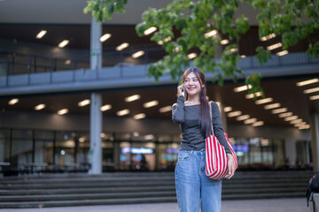 Fototapeta premium University student making a phone call on campus
