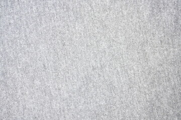 Plain textured gray fabric surface with a close-up pattern detail