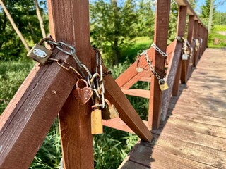 Colorful love locks attached to a charming wooden bridge, symbolizing eternal romance and couples