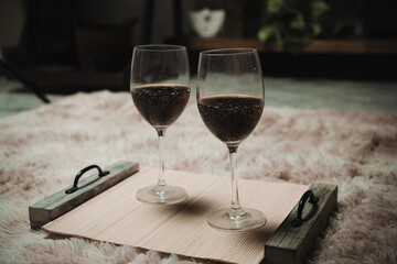 A heterosexual Latino couple having dinner in their living room, sitting on the floor. First-person photography.