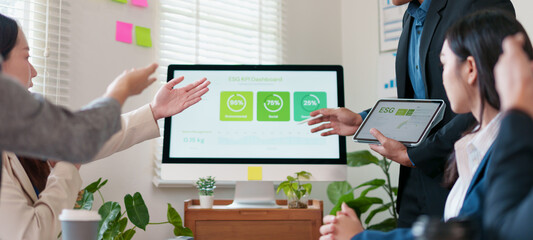 Business meeting, teamwork, presentation, and discussion about ESG dashboard, sustainability, and data analysis in modern office with plants and digital devices