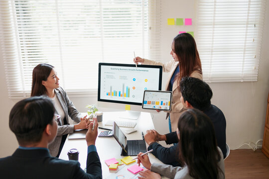 Business meeting, teamwork, office, presentation, and data analysis with diverse professionals discussing growth performance charts on computer and tablet, collaborative and focused atmosphere