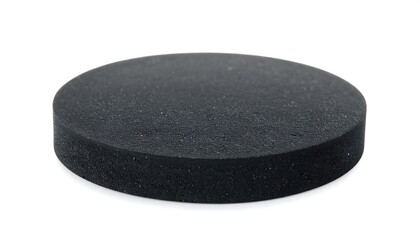 A circular, black foam pad sits on a plain white background.