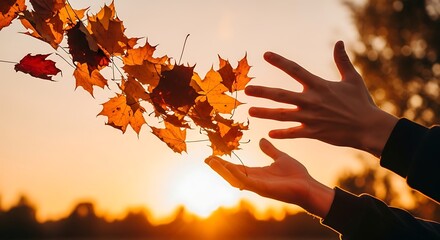 Autumn Leaves Falling in Sunset with Hands Reaching to Catch Them