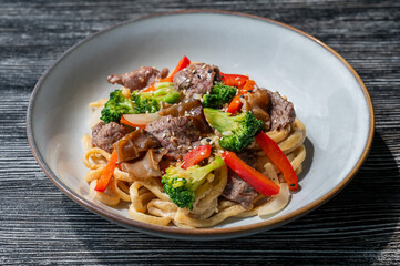 Top view of pasta with beef and broccoli. 