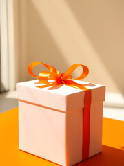 A white gift box with an orange ribbon sits on an orange surface, bathed in sunlight