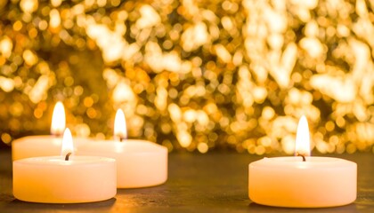 Three warm, glowing candles stand out against a backdrop of golden, blurred lights, creating a peaceful and inviting scene.