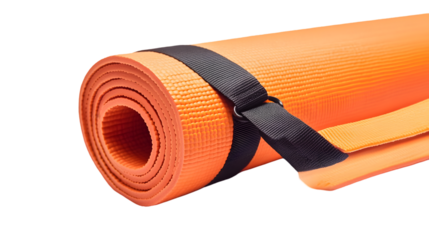 A close up view of a rolled orange yoga mat secured with a black strap on a black background