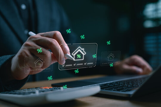 Businessman analyzing home loan interest rates using digital interface and stylus pen. Concept for mortgage application, real estate financing and online housing loan approval system.