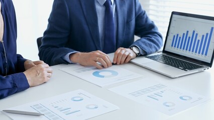 Business people reviewing financial data, discussing and shared documents during collaborative strategy session. Audit and finance concept