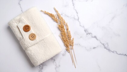 Cozy Bath Towel with Wooden Buttons on a Marble Surface with Dried Grass Accent