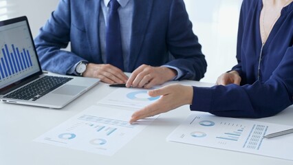 Business people reviewing financial data, discussing and shared documents during collaborative strategy session. Audit and finance concept