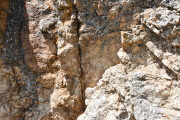 Rock wall with mineral deposits. Crack going down middle.
