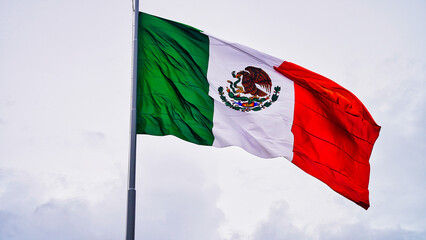 Close up of the Massive Mexican tricolor flag over Plaza de la Independencia or Independence Plaza on a late evening at the historical town center of Merida,Yucatan,Mexico