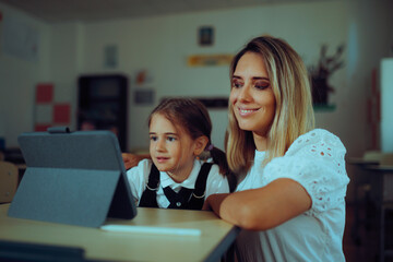 Student and Teacher Working on a Pc Tablet During Class. Professor and pupil during computer science lesson learning online
