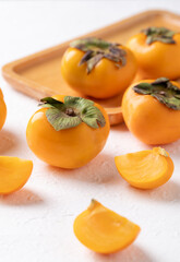 Sliced fresh ripe persimmon on white background, Autumn sweet fruit
