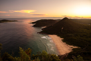 A golden sunset view of Zenith Beach from the summit lookout of Tomaree Head in Port Stephens, New South Wales, Australia.