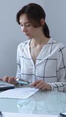 Accountant carefully reviewing financial documents, magnifying details, calculating performance...