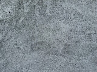 Close up of gray concrete wall surface with rough texture and natural pattern