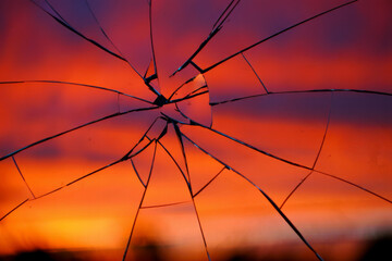 Shattered Glass Reflecting Fiery Sunset: Dramatic, Textured, Abstract Background Image