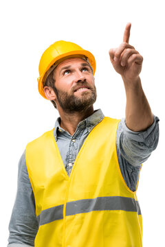 Focused construction worker in yellow hardhat pointing upwards with determination.