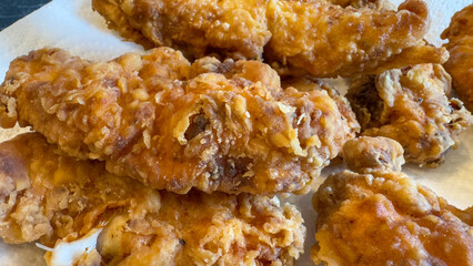 Close-up of crispy homemade fried chicken on a paper towel