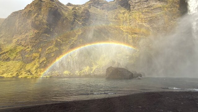 rainbow near icelandic waterfall