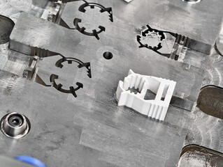 Metal molds for plastic injection molding showcasing a completed component on the manufacturing...